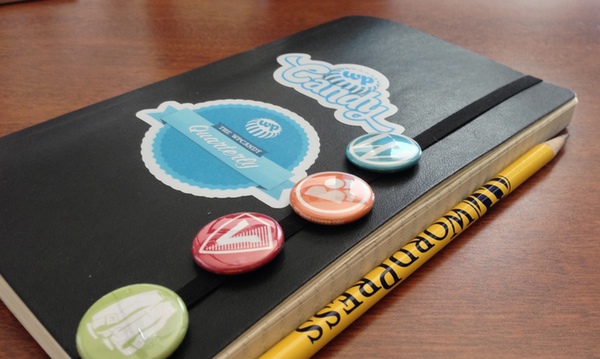 Moleskine with WPCandy Quarterly stickers, button, and pencil
