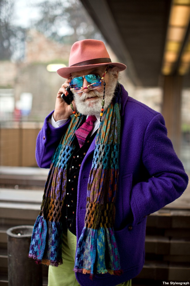 Over-the-top-colorful-outfit-in-green-purple-mirrored-sunglasses-with-reading-glasses