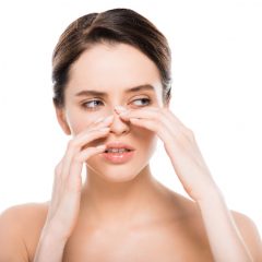 woman-touching-her-nose-7dd69fe5