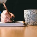 629146c1c7040304df9e1083_Writer-with-Mug-scaled-baf26b6a